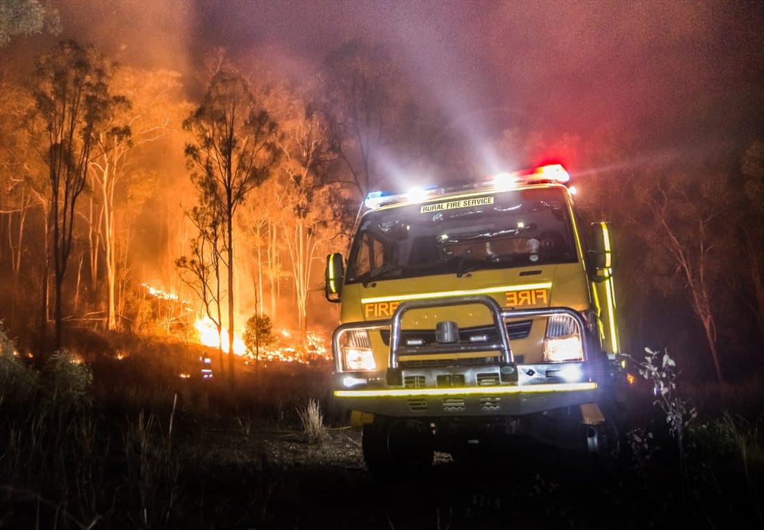 A rural fire service tanker working at a bushfire at night.