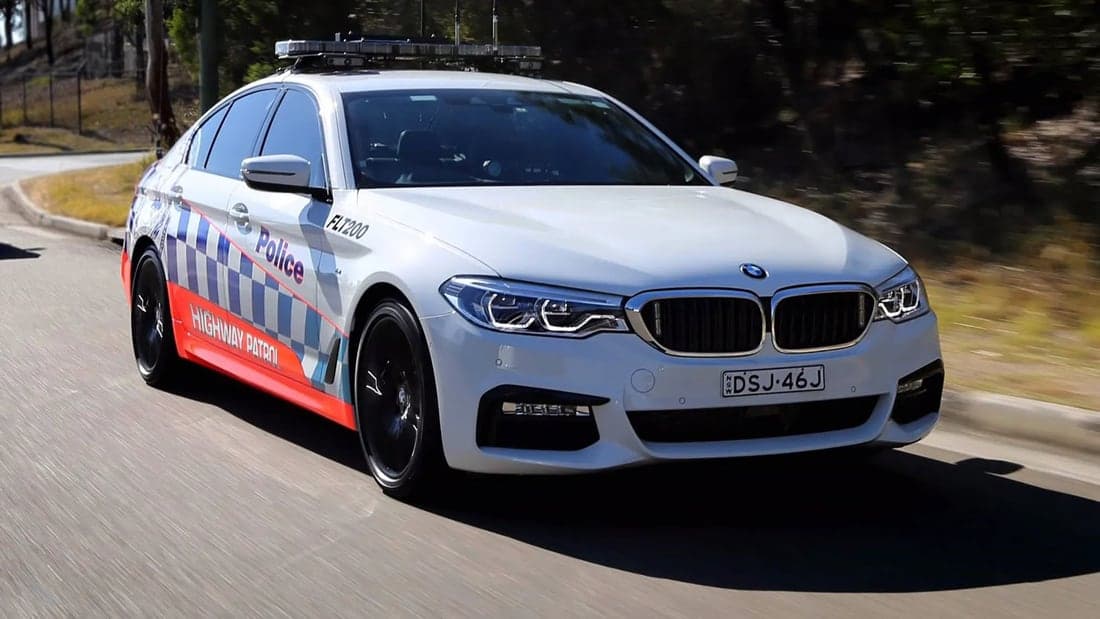 A highway patrol car on the road.